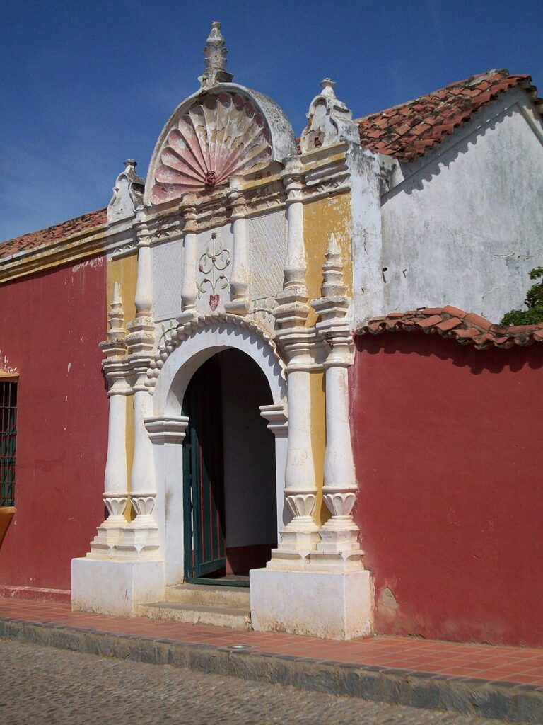Fachada de la Casa de las Ventanas de Hierro en Coro, construcción colonial del siglo XVIII con portón de madera y detalles barrocos, ubicada en el casco histórico Patrimonio de la Humanidad, visita obligada en un recorrido de turismo hostorico en Coro